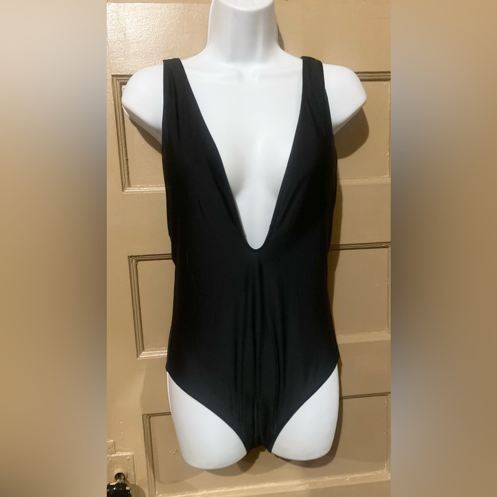 NWOT black one piece bathing suit. Size medium.